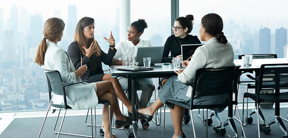 Business people in large modern meeting room